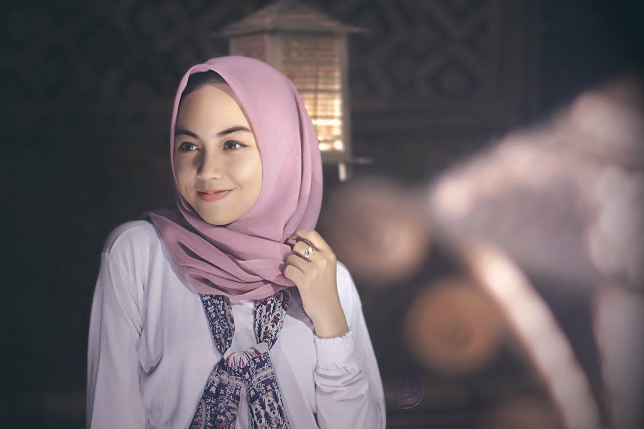 A serene portrait of a woman wearing a pink hijab, exuding grace and elegance.